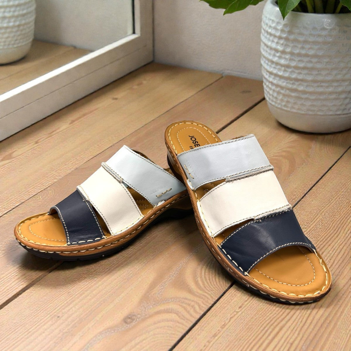 Josef Seibel Catalonia 86 wedge sandals in ocean blue and white leather with a slip-on design.
photo of the front.