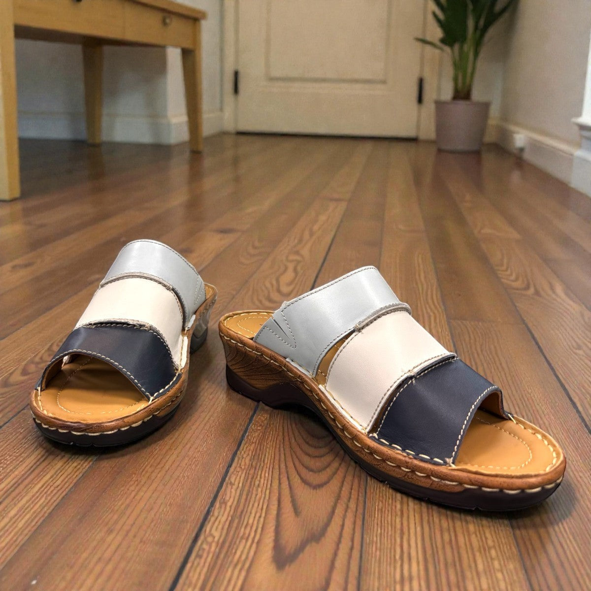 Josef Seibel Catalonia 86 wedge sandals in ocean blue and white leather with a slip-on design. photo of the front.