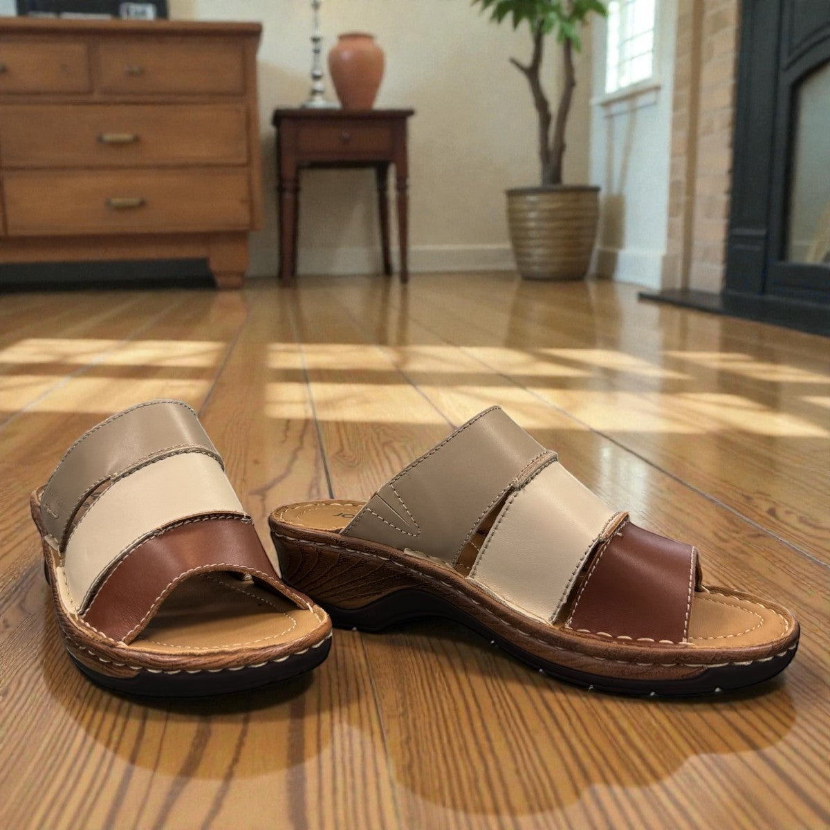 Josef Seibel Catalonia 86 cognac and beige leather wedge slide sandals with open toe design.
photo of the front.