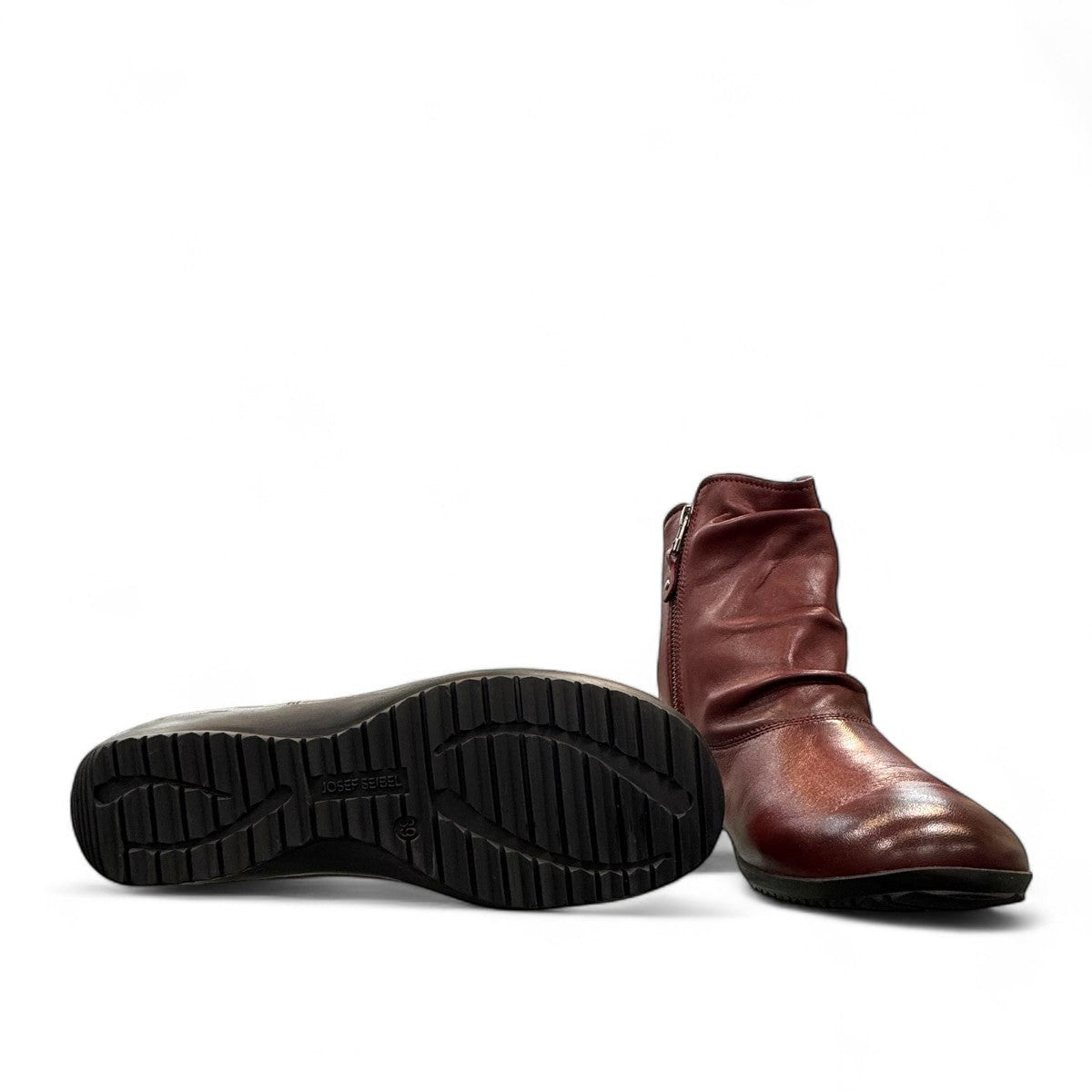 Josef Seibel Naly 24 bordo leather ruched ankle boot with side zips and a low wedge sole. photo of the bottom.