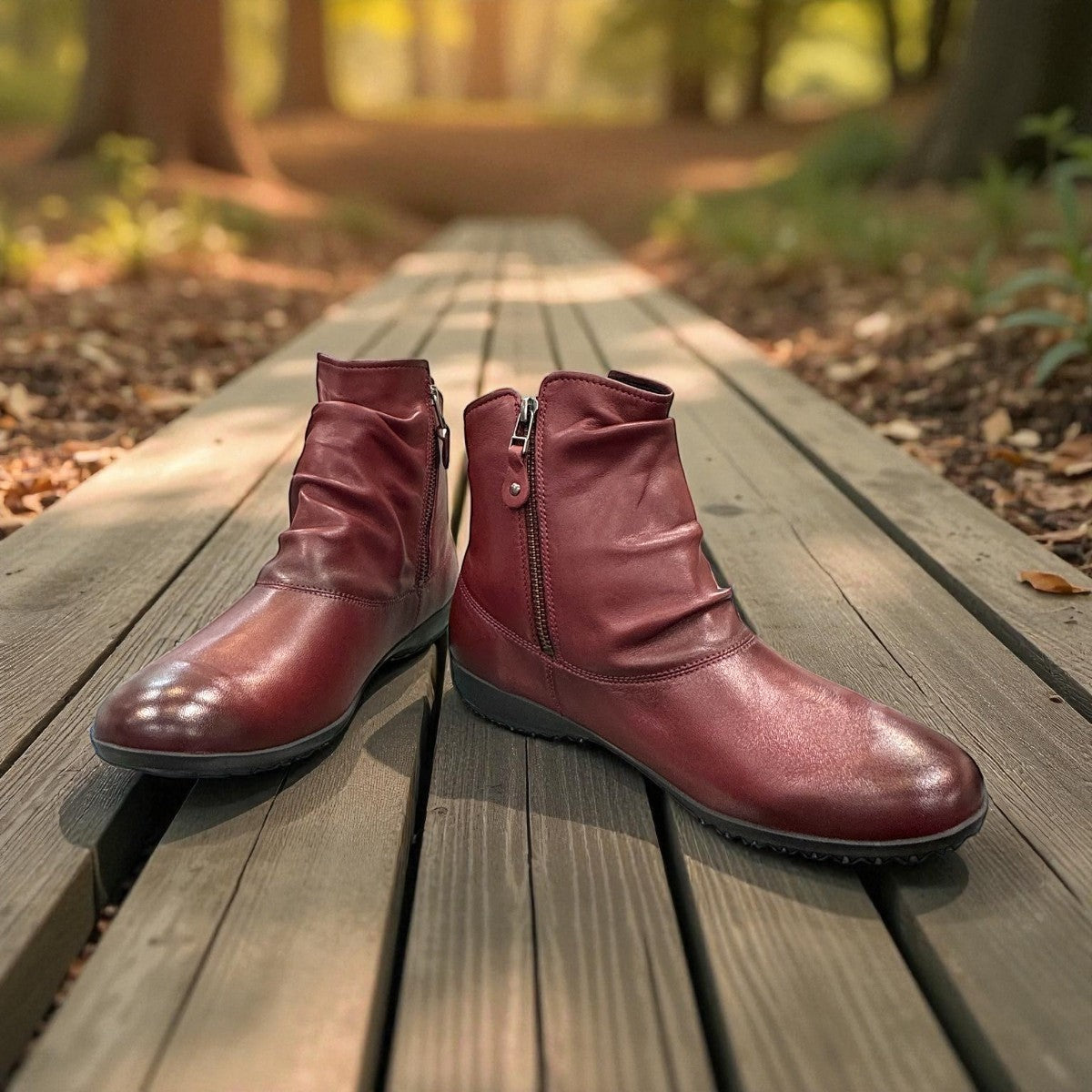 Josef Seibel Naly 24 bordo leather ruched ankle boot with side zips and a low wedge sole. photo of the front.