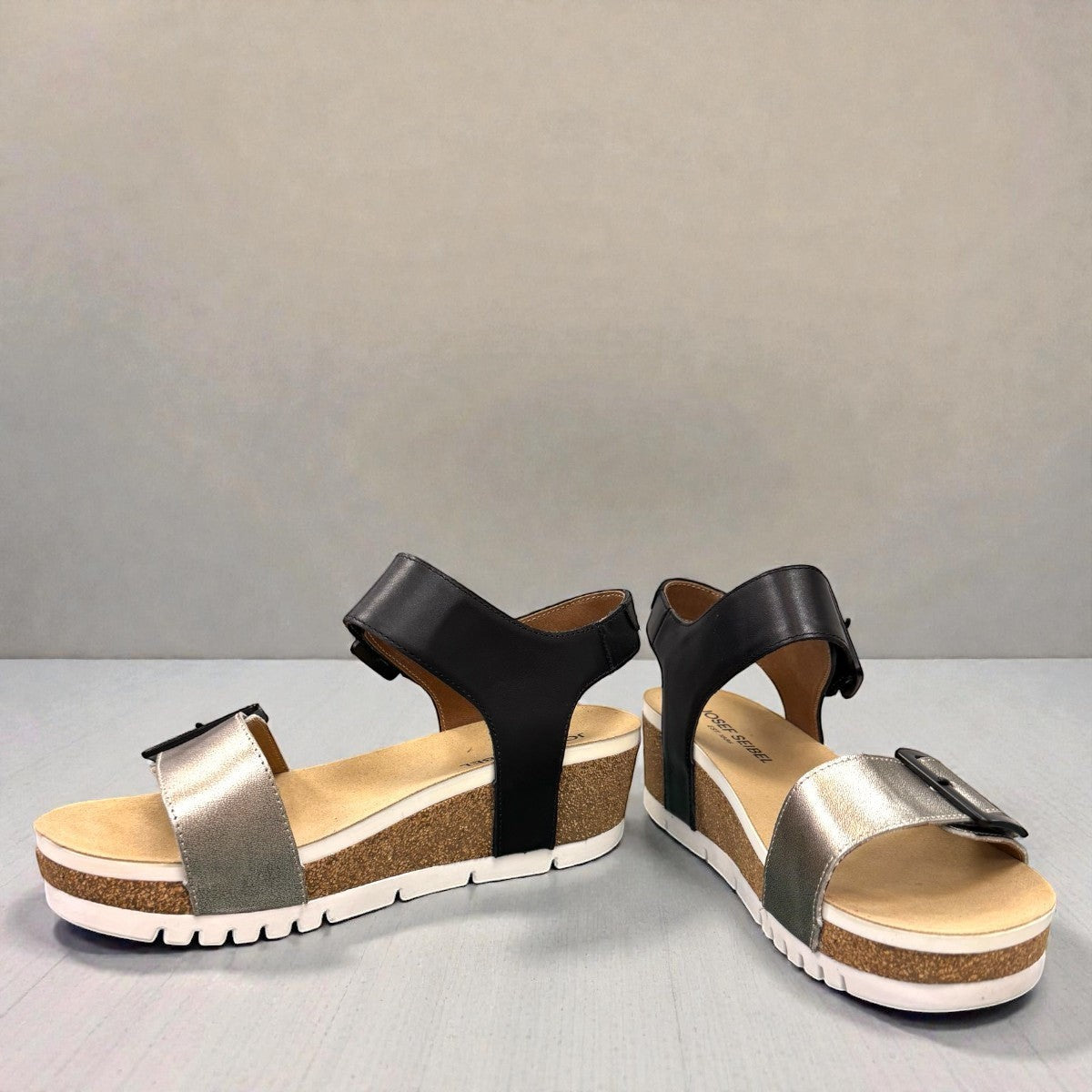 Josef Seibel Quinn 02 wedge sandal in basalt kombi leather with adjustable straps and cork midsole.
photo of the front.