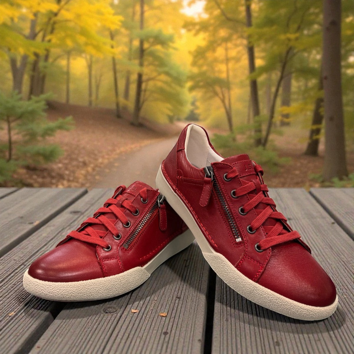 Josef Seibel Claire 03 hibiscus red leather sneaker with side zip and white rubber sole.photo of the front.