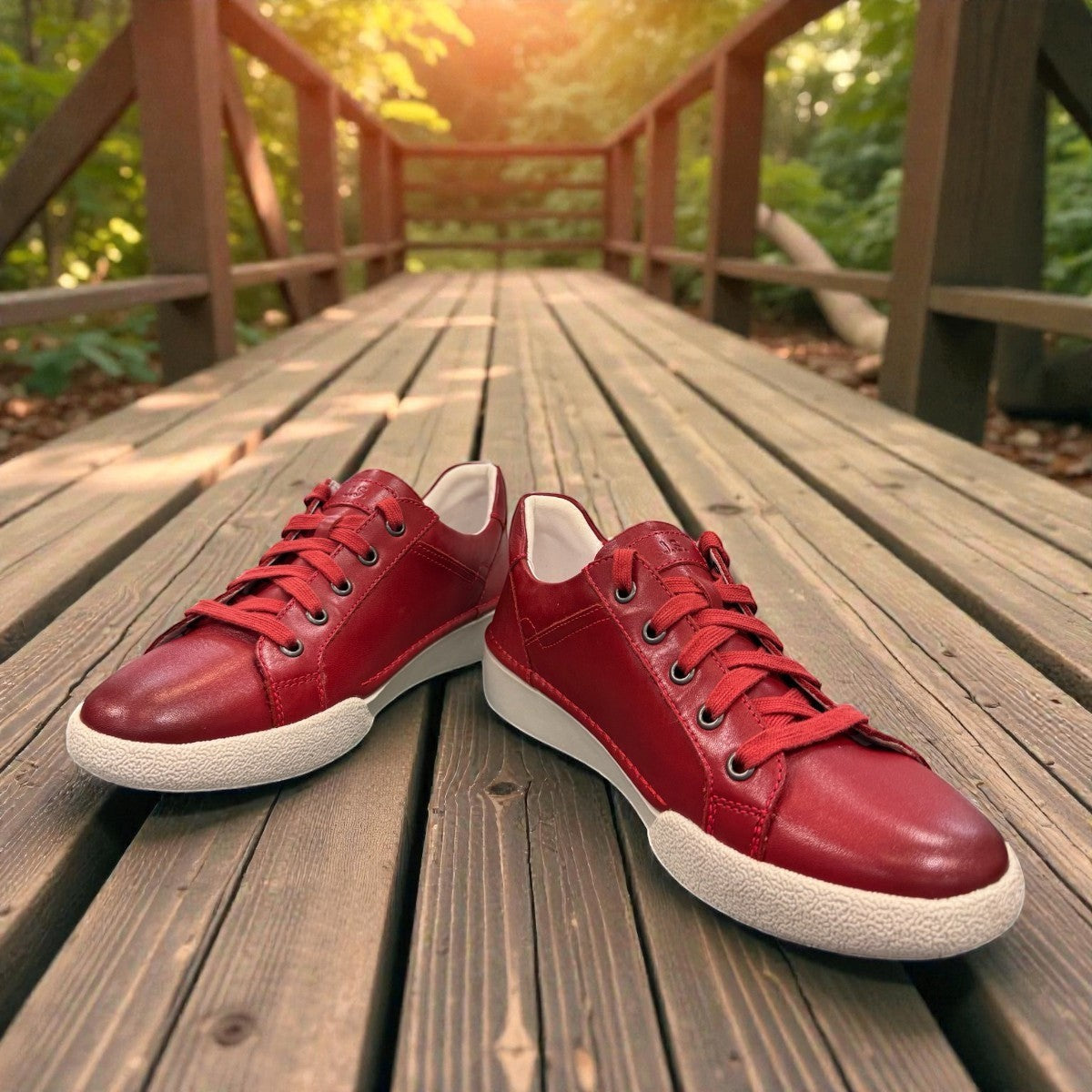 Josef Seibel Claire 03 hibiscus red leather sneaker with side zip and white rubber sole. photo of the front.