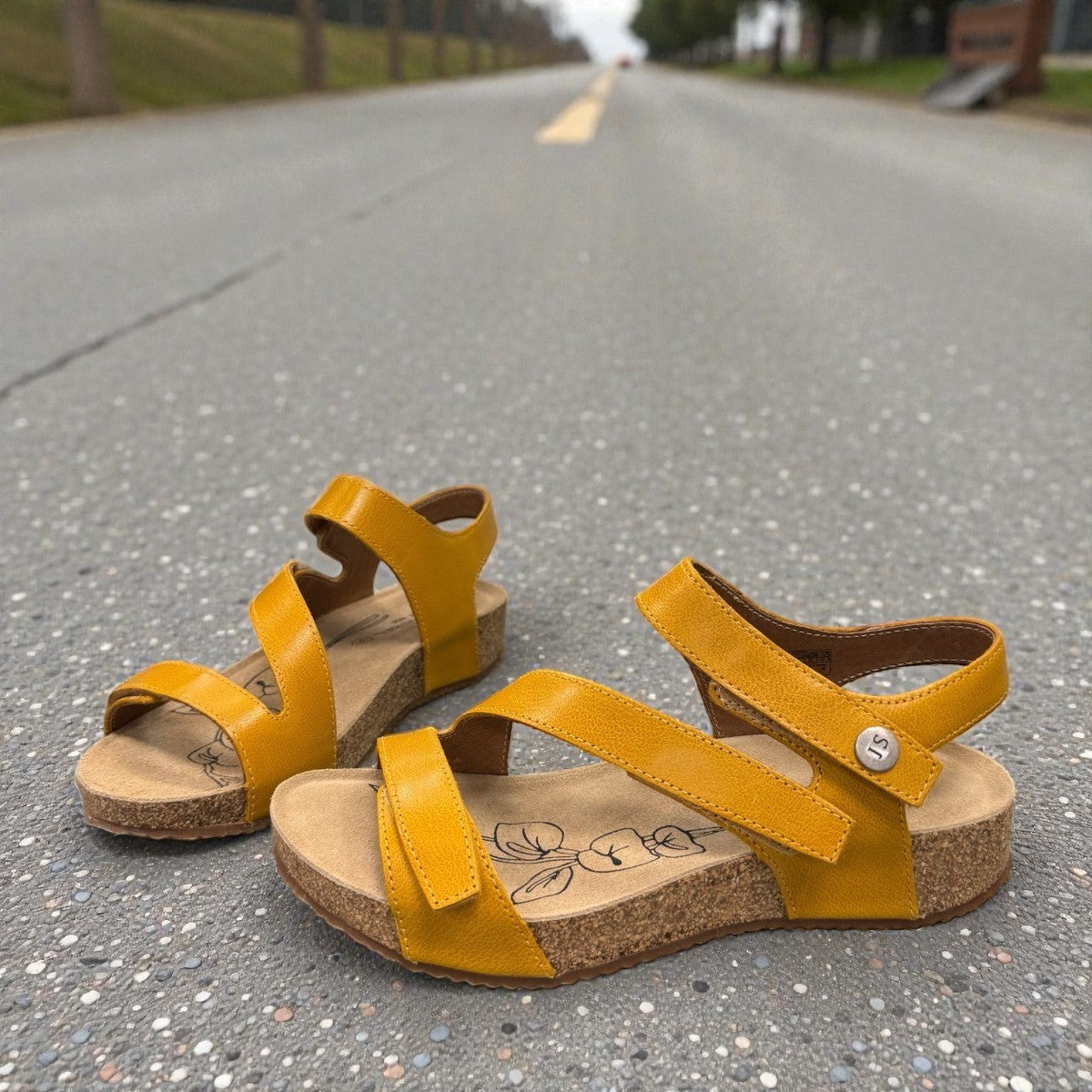 Josef Seibel Tonga 25 yellow leather sandal with three adjustable hook and loop straps and cork midsole. photo of the front.