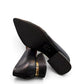 LouJo Betty black leather pump with a pointed toe, pleated detail, and a low sculpted metallic heel.