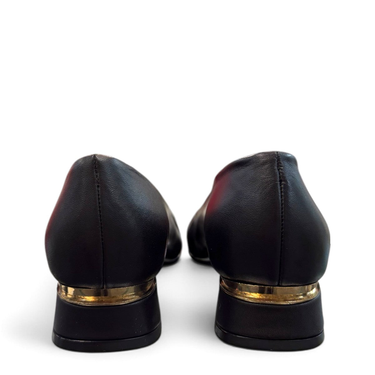 LouJo Betty black leather pump with a pointed toe, pleated detail, and a low sculpted metallic heel.