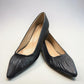 LouJo Betty black leather pump with a pointed toe, pleated detail, and a low sculpted metallic heel.