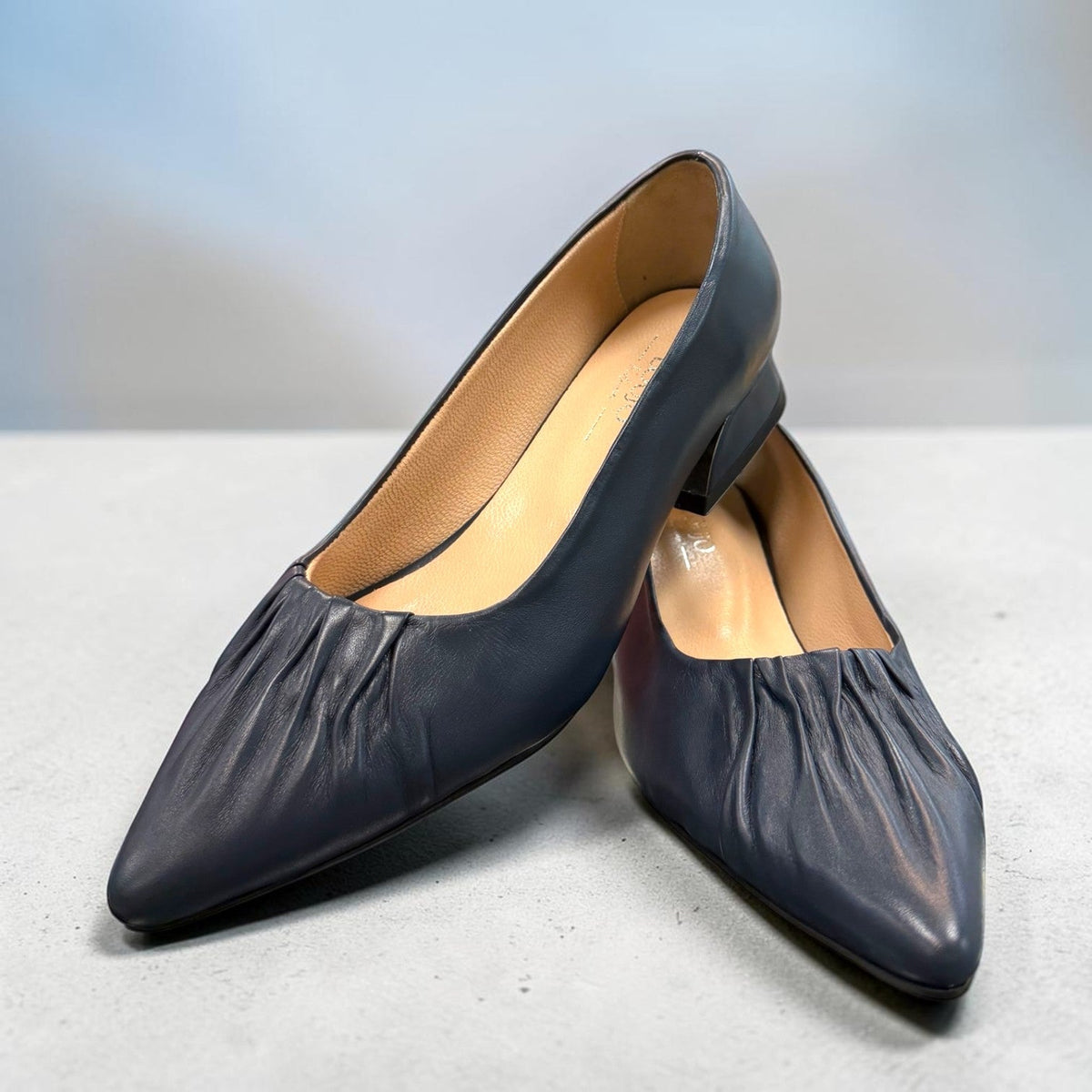 LouJo Betty navy leather pump with a pleated pointed toe and low sculpted metallic heel