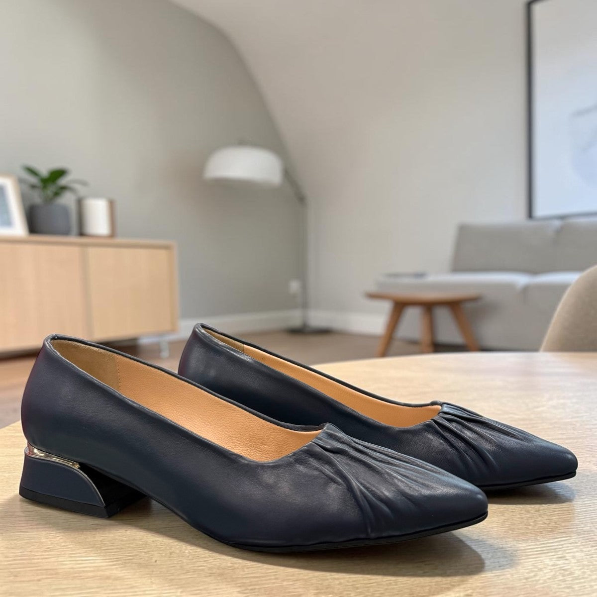 LouJo Betty navy leather pump with a pleated pointed toe and low sculpted metallic heel