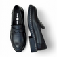 Luna sole pinky black leather loafer with a thick sole featuring white speckled detailing along the welt. Photo of upper view.