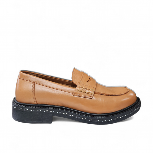 Luna Sole loafer in light tan smooth leather with a saddle strap, thick dark sole, and white speckled edge. Photo of right side view.
