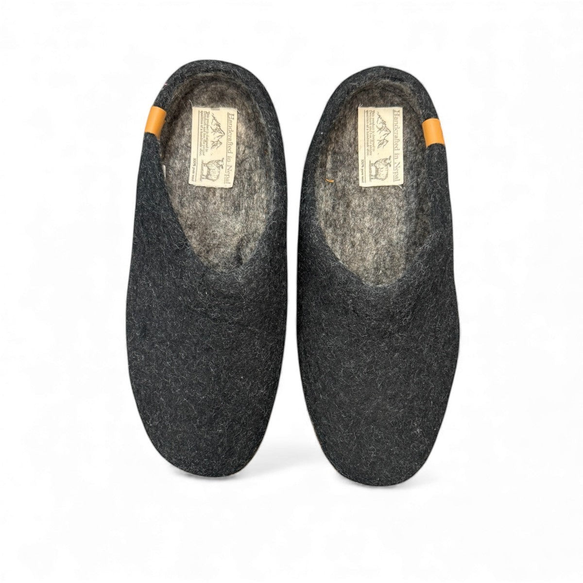 Makalu black wool slippers handcrafted in Nepal with EnergySole insoles and tan leather heel detail.