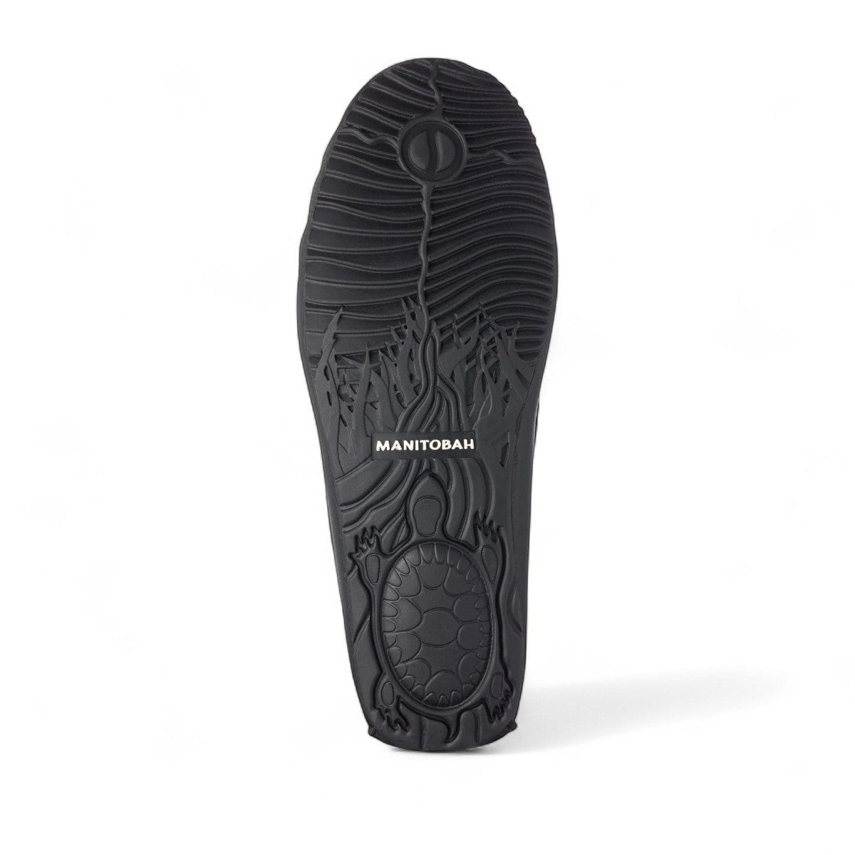 Manitobah Kayak moccasin in onyx black showing the detailed turtle tread rubber sole design