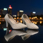 Nikpa Belle silver women's pumps featuring pearl and rhinestone embellishments on a reflective surface.