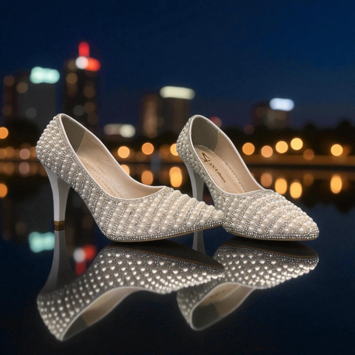 Nikpa Belle silver women's pumps featuring pearl and rhinestone embellishments on a reflective surface.