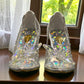 NIKPA BIRILIANT white high heel pump with clear side panels and a large crystal flower embellishment