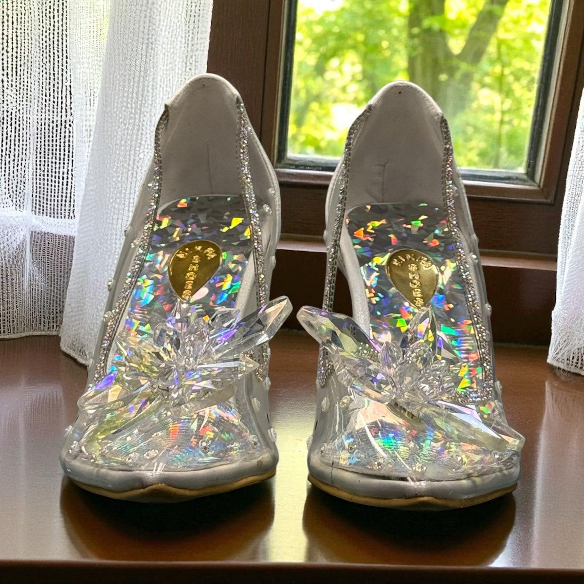 NIKPA BIRILIANT white high heel pump with clear side panels and a large crystal flower embellishment