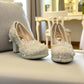 NIKPA FOXY white bridal block heel shoe with handmade floral lace, pearl embellishments, and platform.