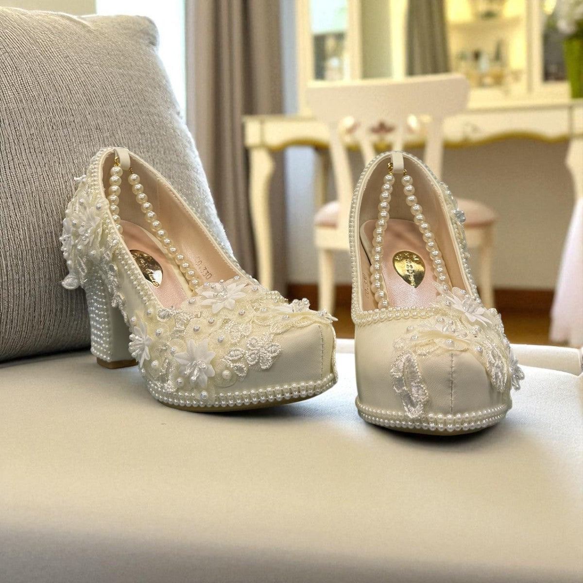 NIKPA FOXY white bridal block heel shoe with handmade floral lace, pearl embellishments, and platform.