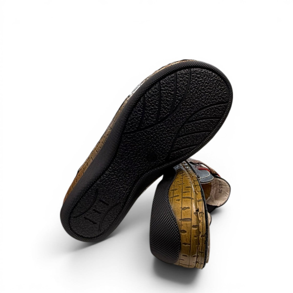 ortho-flex-S6132L black leather comfort clogs with multi-tone strap details, contrast stitching, and a low wedge sole.
photo of the bottom side