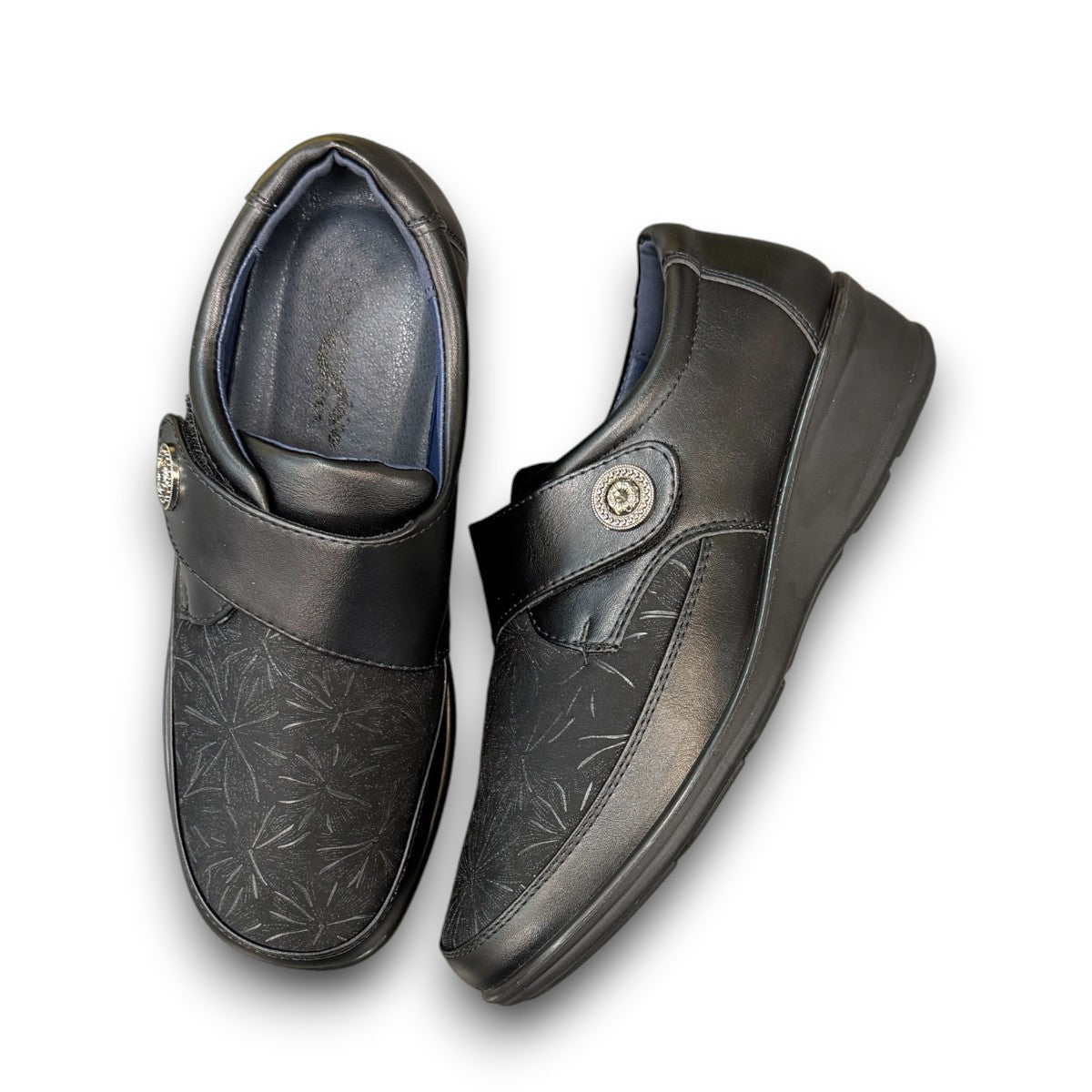 ORTHO FLEX F8244 black comfort shoe with adjustable strap, textured accents, and cushioned sole.
photo of the top side