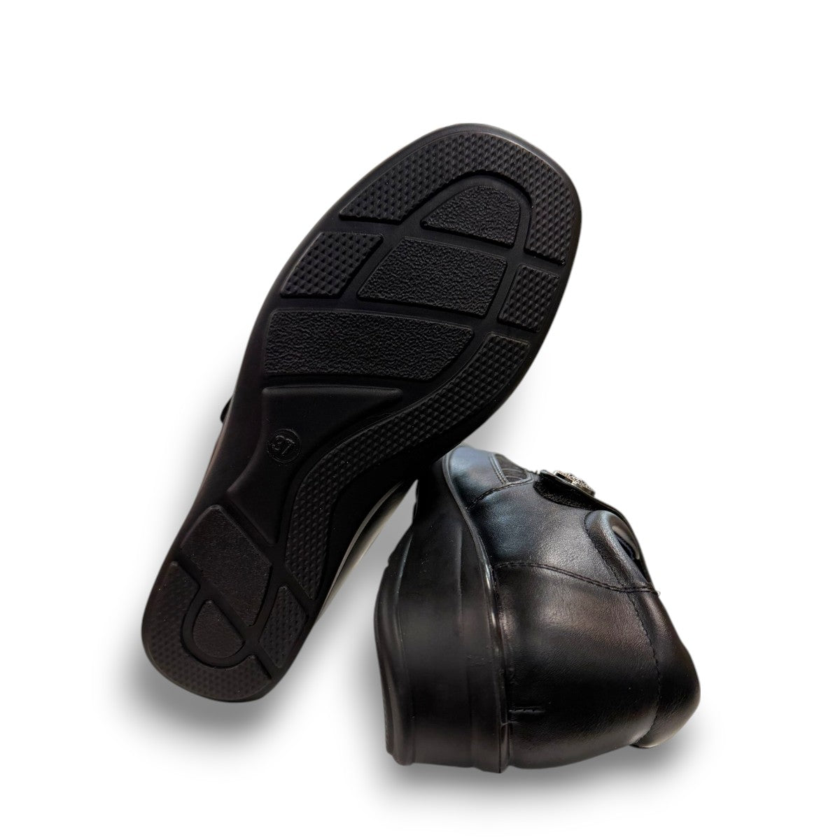 ORTHO FLEX F8244 black comfort shoe with adjustable strap, textured accents, and cushioned sole.
photo of the bottom side