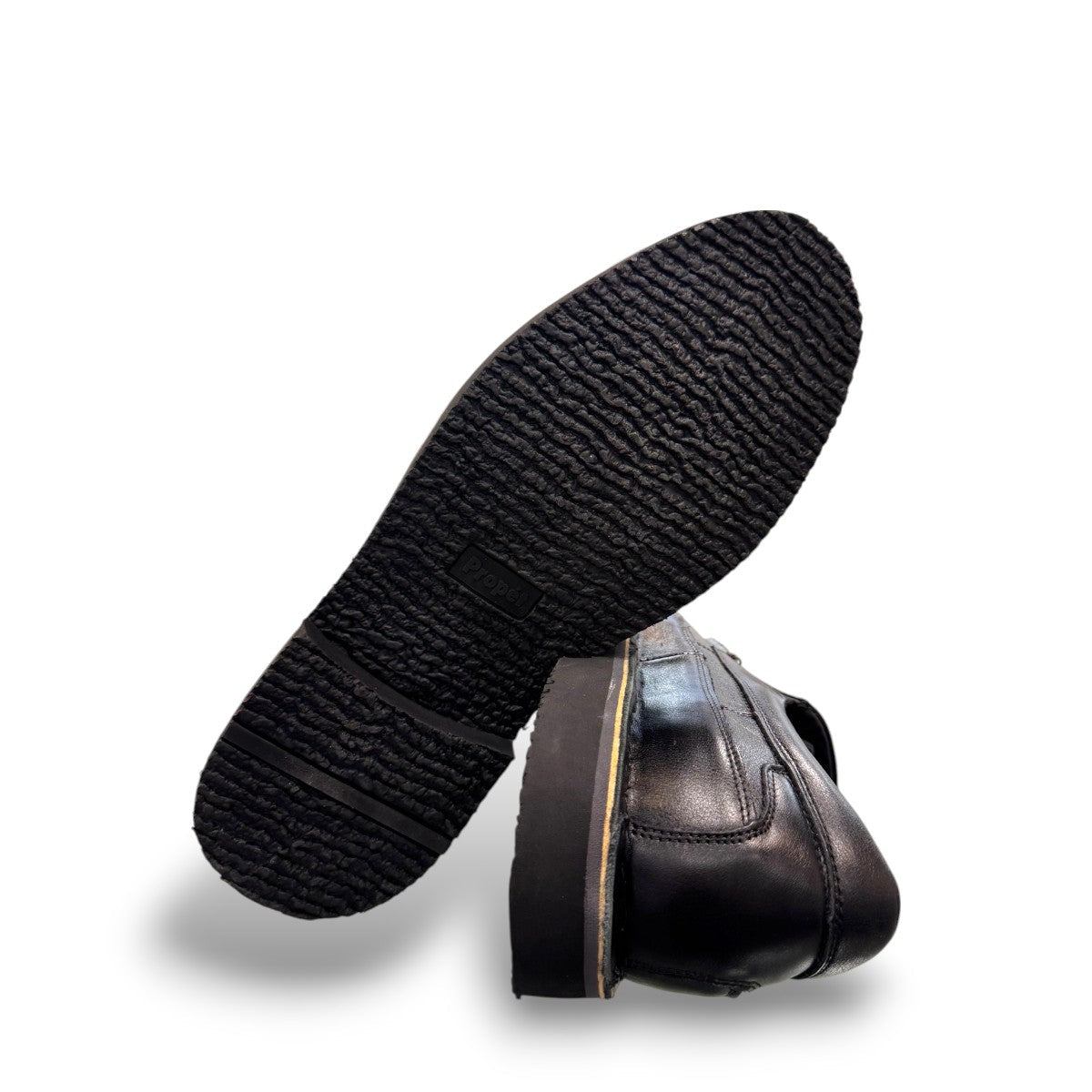 Propet Flynn black leather slip-on shoe with twin gore panels and a durable rubber outsole.
photo of the bottom side