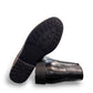 Propet Truman black leather Chelsea boot with elastic side panel and durable lugged TPR outsole.
photo of the bottom side