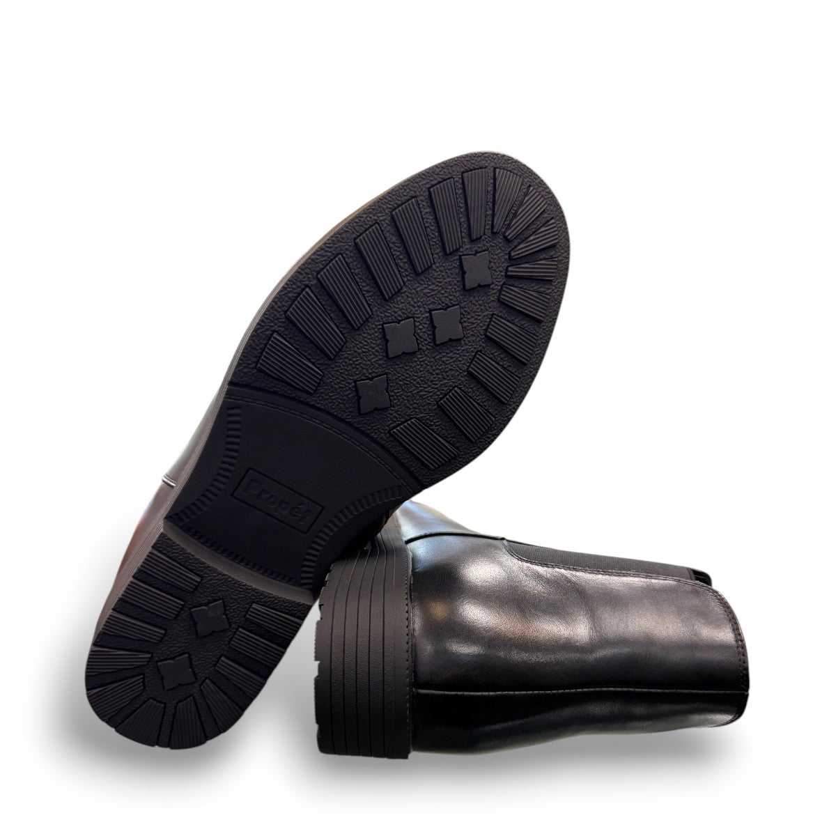 Propet Truman black leather Chelsea boot with elastic side panel and durable lugged TPR outsole.
photo of the bottom side