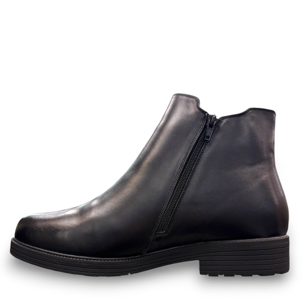 Propet Truman black leather Chelsea boot with elastic side panel and durable lugged TPR outsole.
photo of the left side