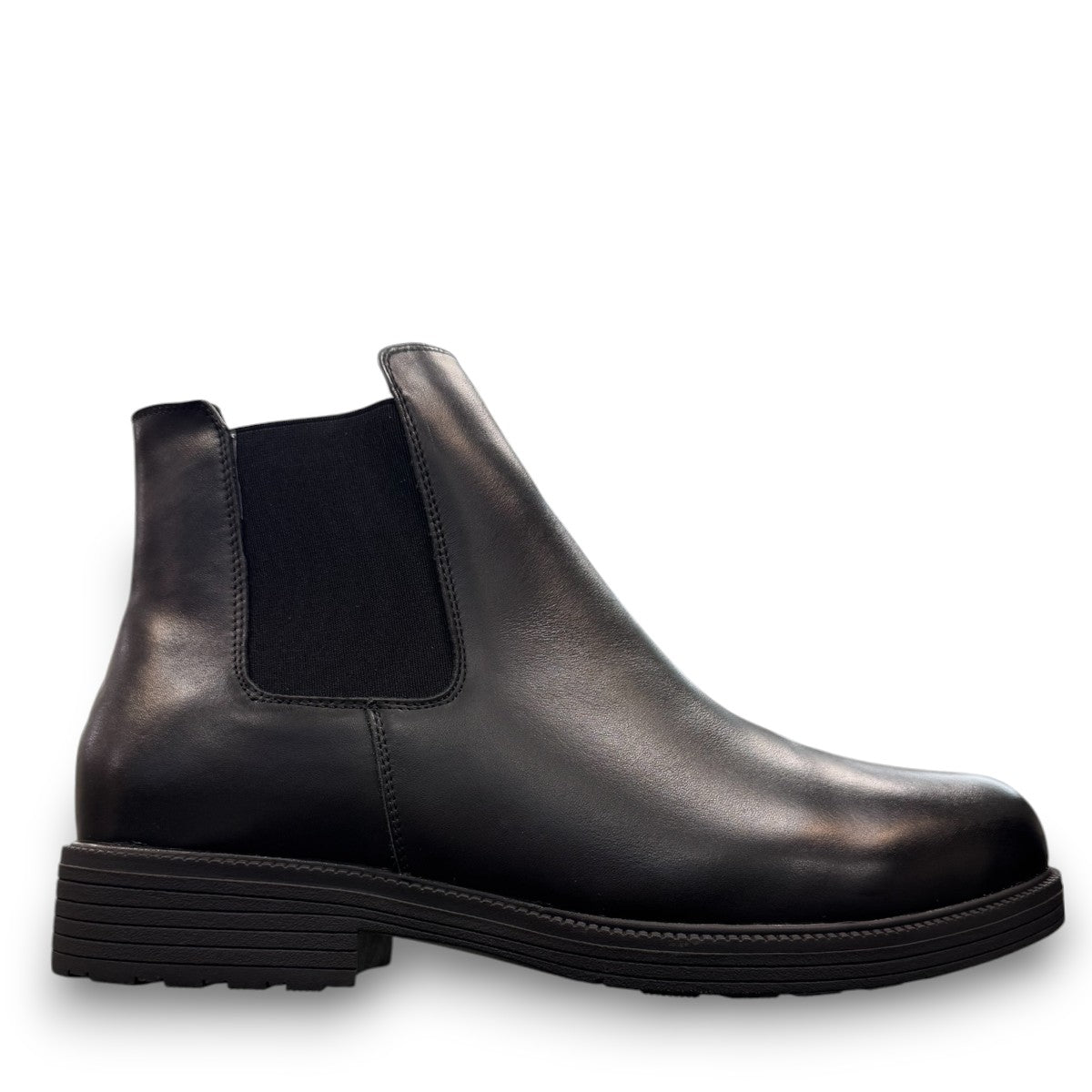 Propet Truman black leather Chelsea boot with elastic side panel and durable lugged TPR outsole.
photo of the right side