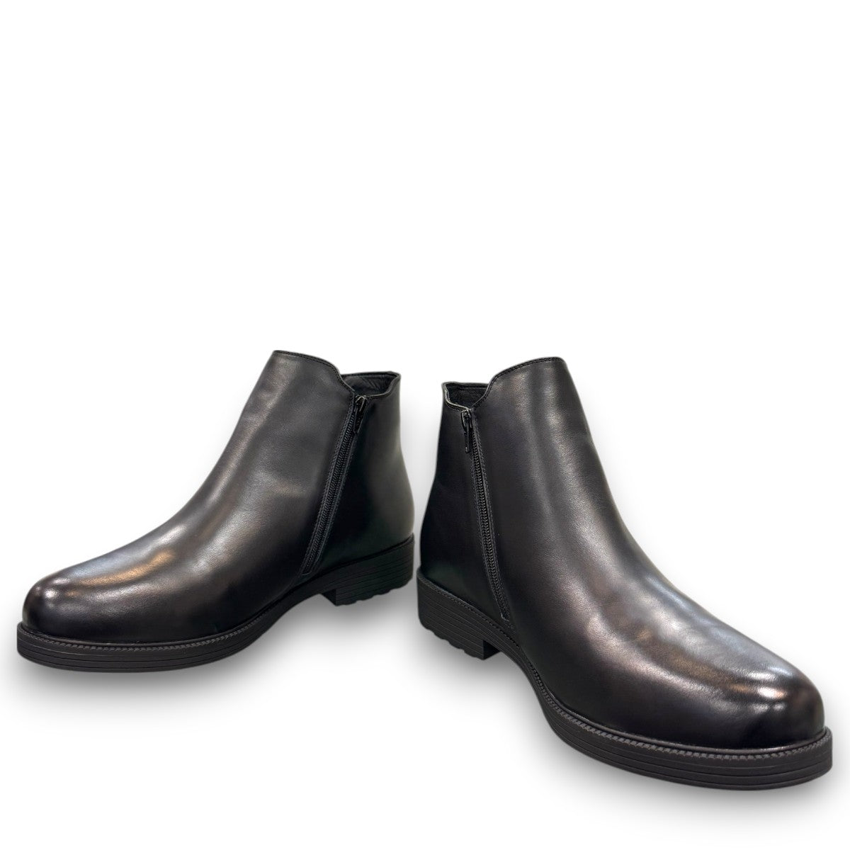 Propet Truman black leather Chelsea boot with elastic side panel and durable lugged TPR outsole.
photo of the front side