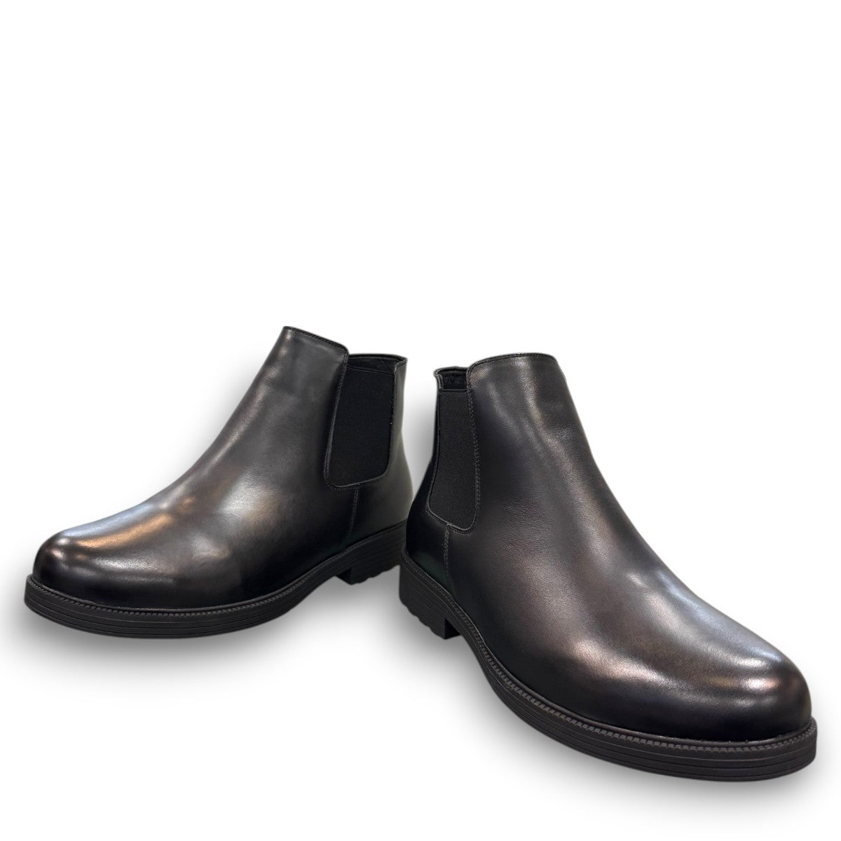Propet Truman black leather Chelsea boot with elastic side panel and durable lugged TPR outsole.
photo of the front side