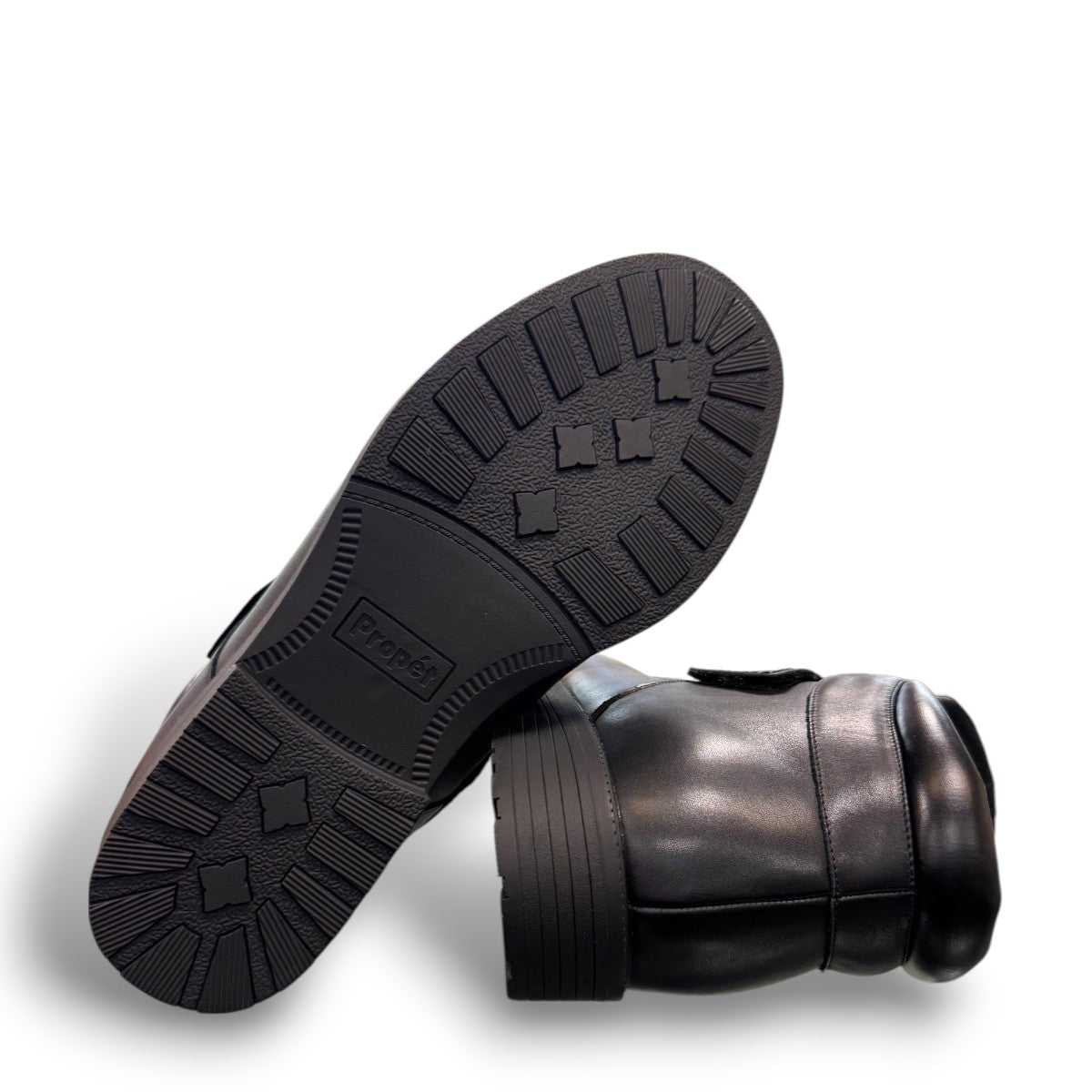 Propet Tyler black leather waterproof boot with hook and loop strap and rugged TPR outsole.
photo of the bottom side