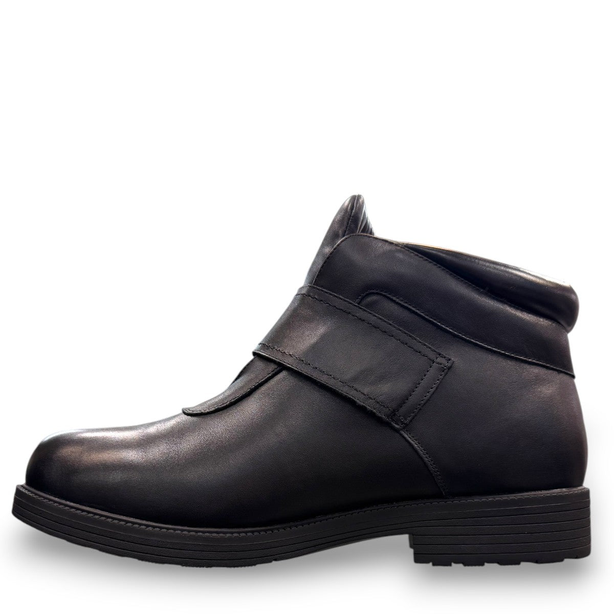 Propet Tyler black leather waterproof boot with hook and loop strap and rugged TPR outsole.
photo of the left side