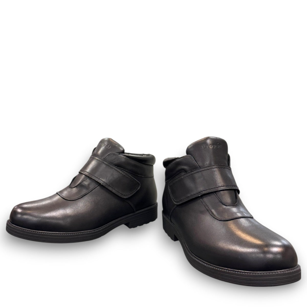 Propet Tyler black leather waterproof boot with hook and loop strap and rugged TPR outsole.
photo of the front side