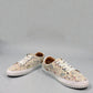 Roamers Audrey taupe leather sneaker with floral pattern, side zipper, and white rubber outsole.
photo of the front side