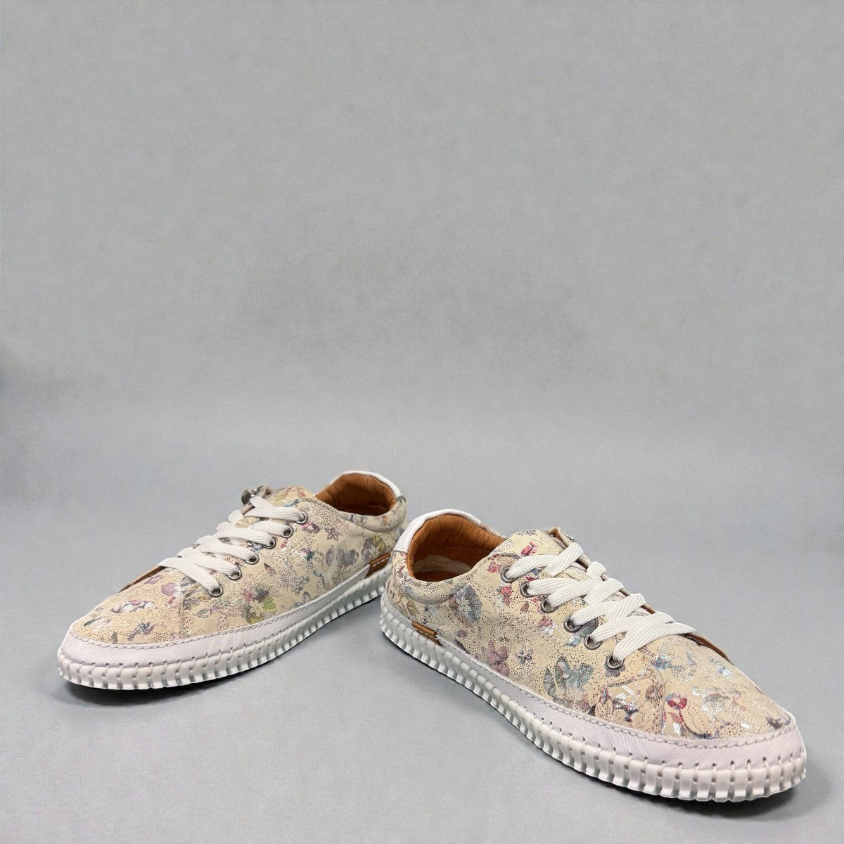 Roamers Audrey taupe leather sneaker with floral pattern, side zipper, and white rubber outsole.
photo of the front side