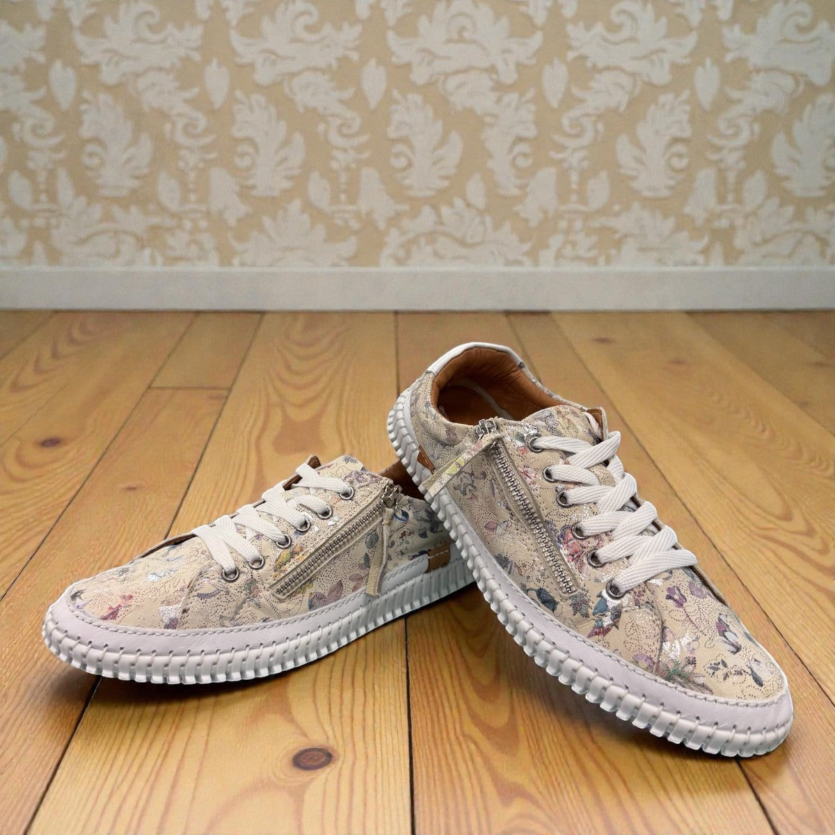 Roamers Audrey taupe leather sneaker with floral pattern, side zipper, and white rubber outsole.
photo of the front side