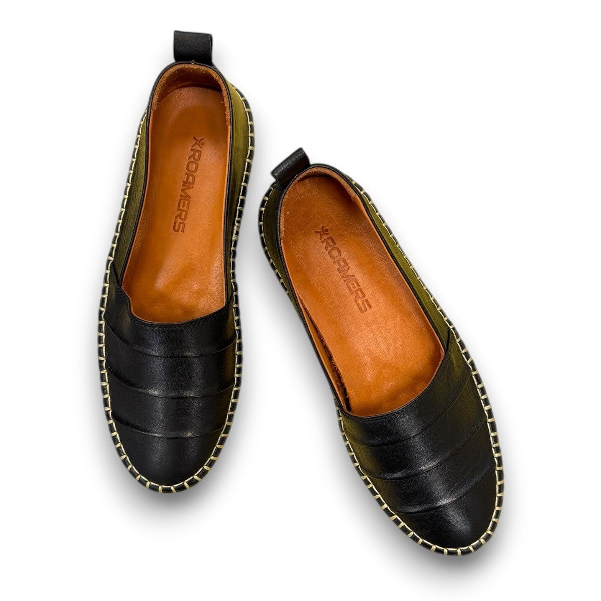 Roamers Avery black leather flat with decorative whipstitch detailing and a durable rubber sole.
photo of the top side