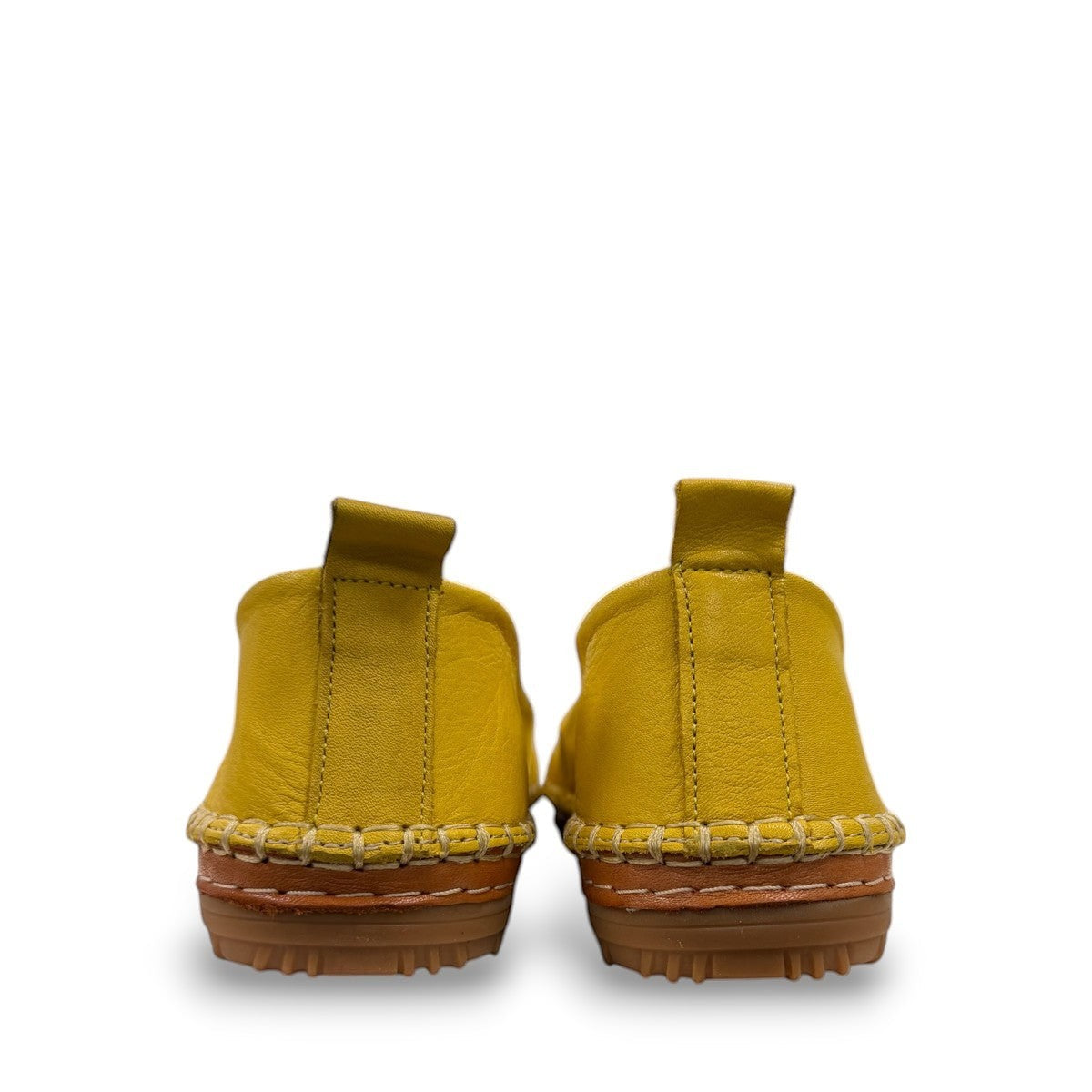Roamers Avery yellow leather flat with cutout details and stitched rubber sole, side view.
photo of the back side
