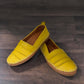 Roamers Avery yellow leather flat with cutout details and stitched rubber sole, side view.
photo of the front side