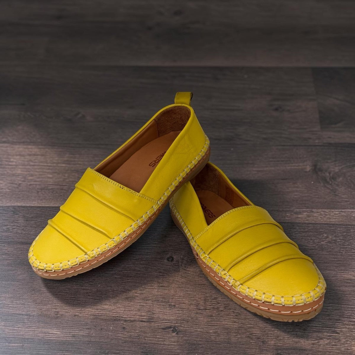 Roamers Avery yellow leather flat with cutout details and stitched rubber sole, side view.
photo of the front side
