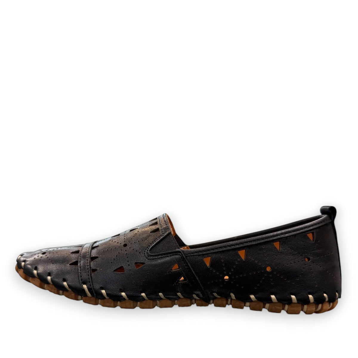 roamers black leather slip-on loafer with geometric laser cutouts, artisan stitching, and flexible rubber sole.
photo of the left side