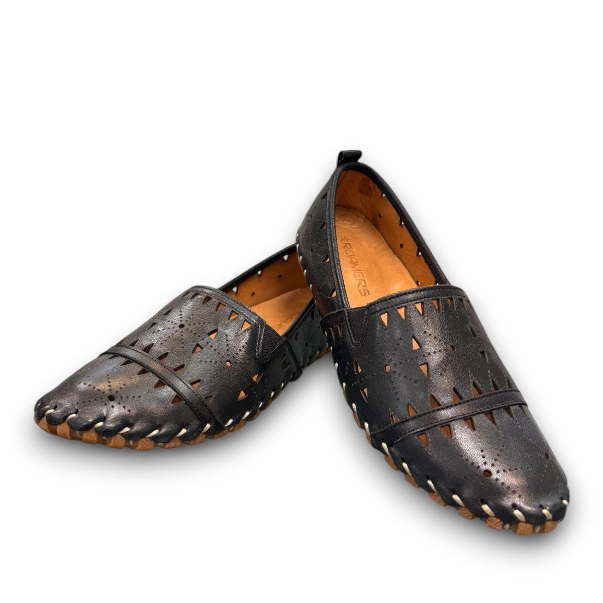 roamers black leather slip-on loafer with geometric laser cutouts, artisan stitching, and flexible rubber sole.
photo of the front side