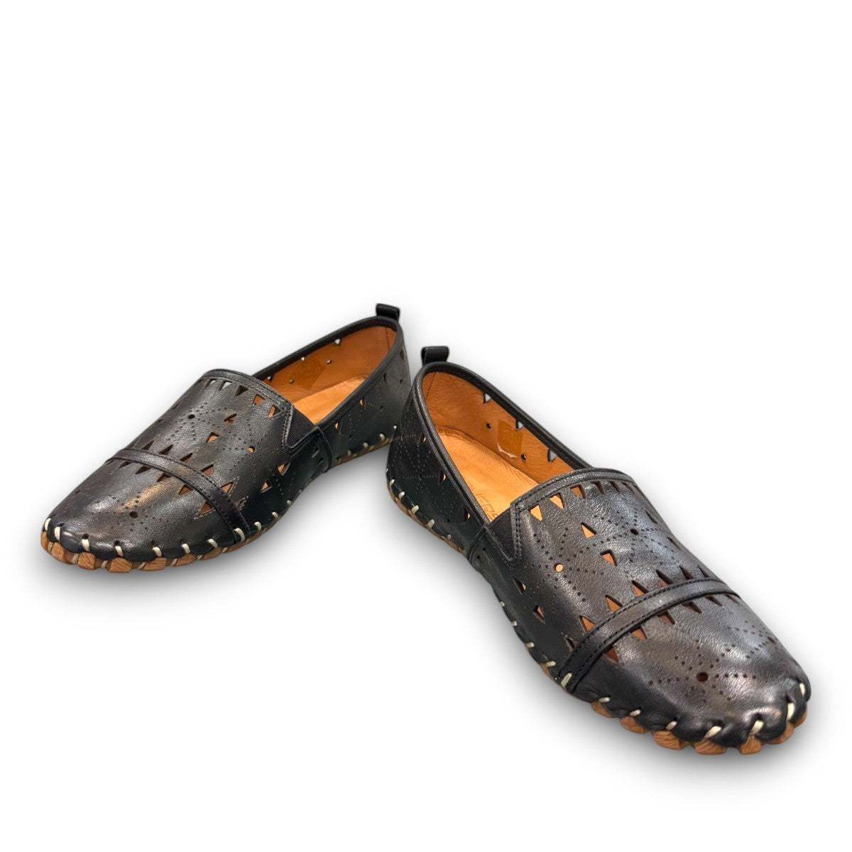 roamers black leather slip-on loafer with geometric laser cutouts, artisan stitching, and flexible rubber sole.
photo of the front side
