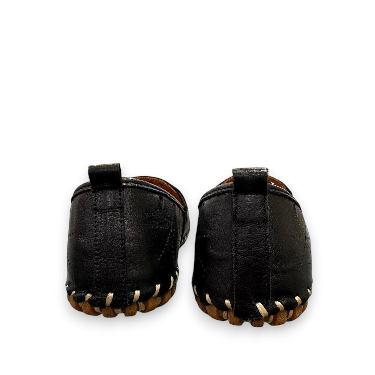 roamers black leather slip-on loafer with geometric laser cutouts, artisan stitching, and flexible rubber sole.
photo of the back side