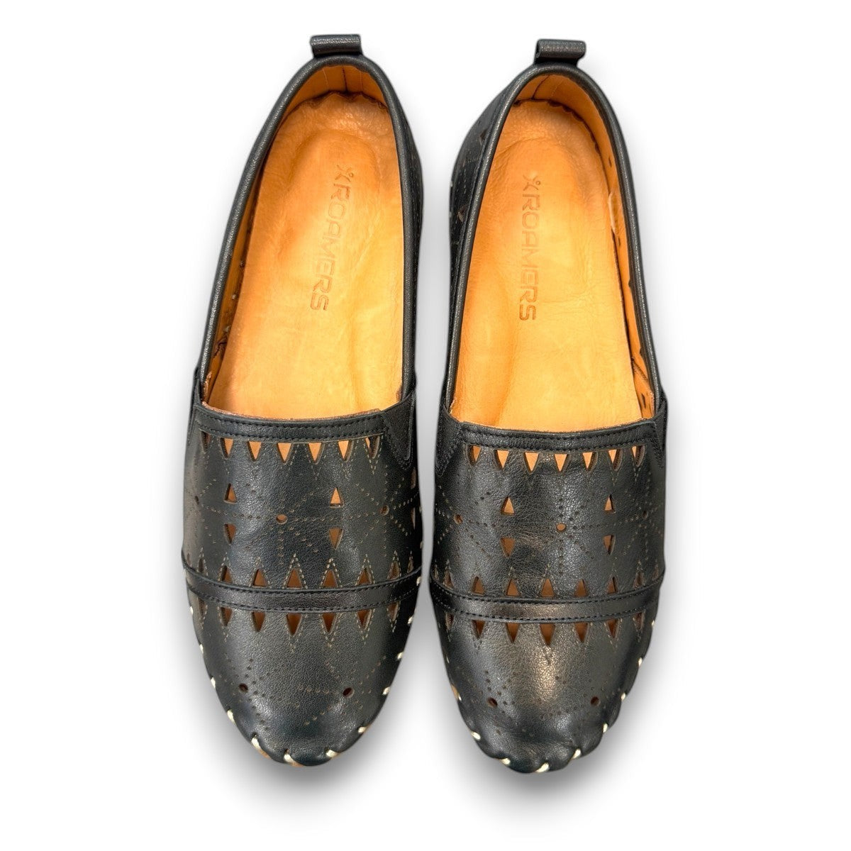 roamers black leather slip-on loafer with geometric laser cutouts, artisan stitching, and flexible rubber sole.
photo of the top side