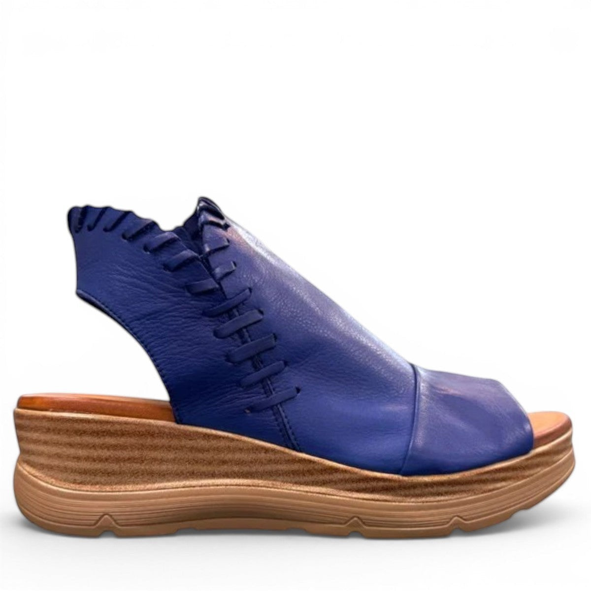 Roamers Eden sax blue leather wedge sandal with side zipper and decorative whipstitch detailing.
photo of the right side